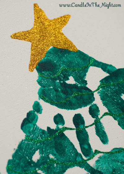 You'll have a piece of art worthy of hanging on your wall when your family makes this handprint Christmas tree together! | candleinthenight.com