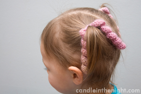 This super simple twirly hair tie crochet pattern works up in no time at all! A great gift for a little girl in your life!