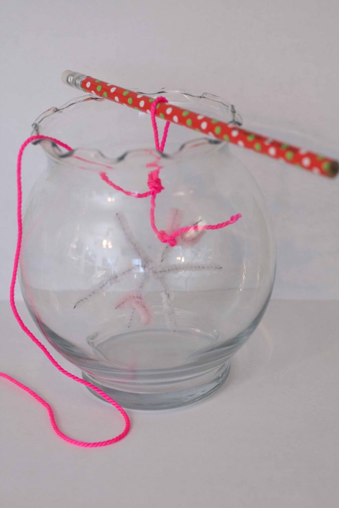 Picture of pipe cleaner snowflake hanging in empty vase.