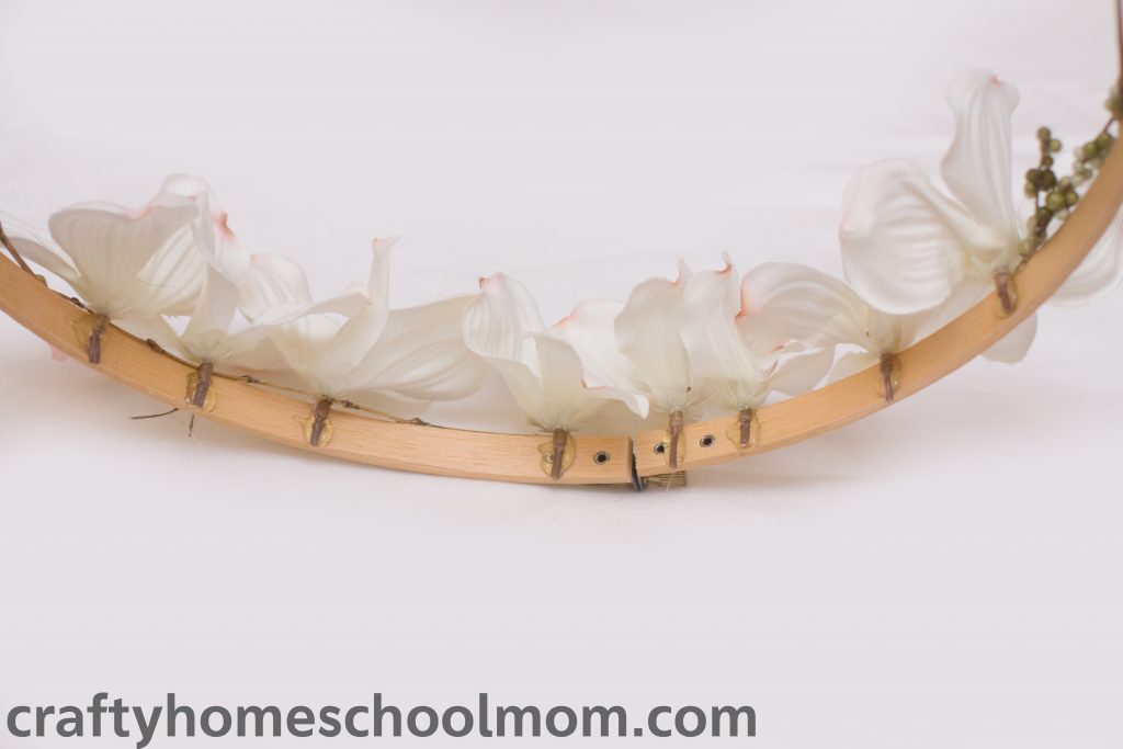 Gluing the dogwood blossoms onto the wreath. 
