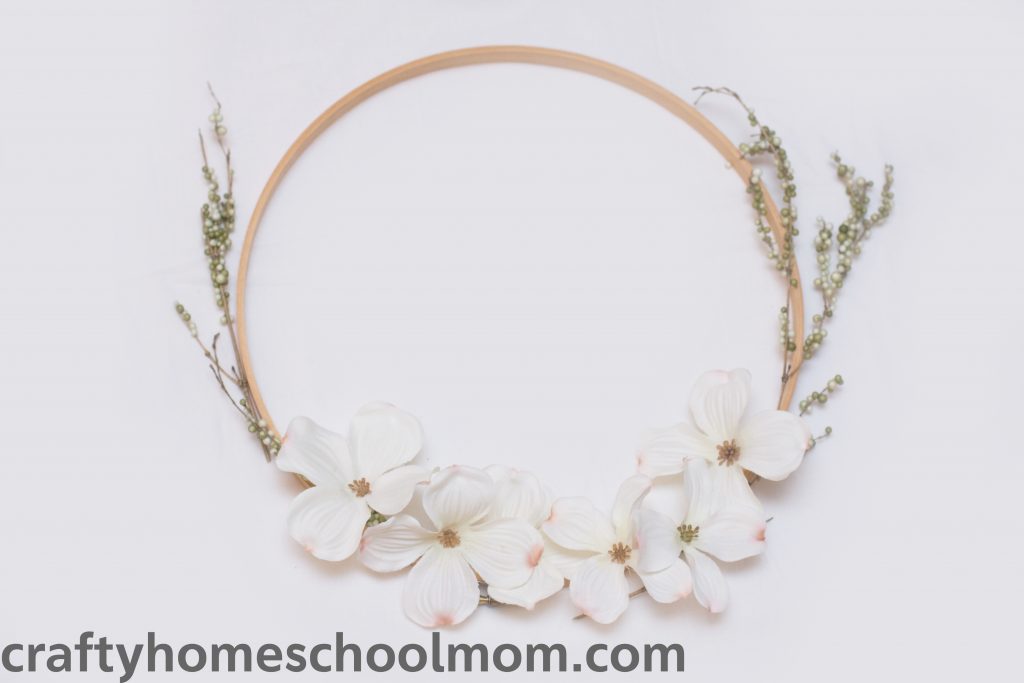 Lay out your pieces on the dogwood wreath to determine where to glue. 